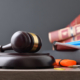 Concept of studying law career with books and class tools and gavel on wood table and isolated dark background. Front view.