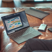 a laptop computer sitting on top of a leather couch