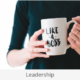 a woman holding a coffee mug with the words like a boss on it