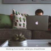 a man sitting on a couch using a laptop computer