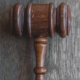 a wooden judge's hammer on top of a wooden table
